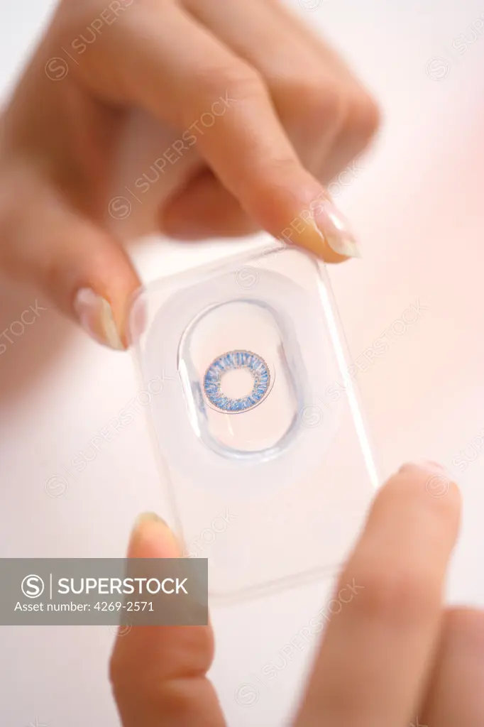 Woman using a colored contact lens.