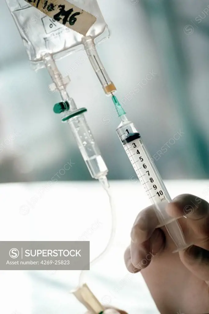Euthanasia. Injection of medication in to a drip system.