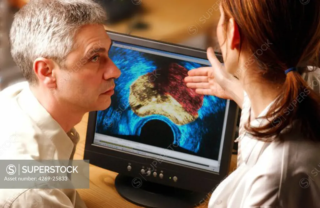 Medical consultation. Doctor examining an ultrasound scan of prostate cancer with a patient.