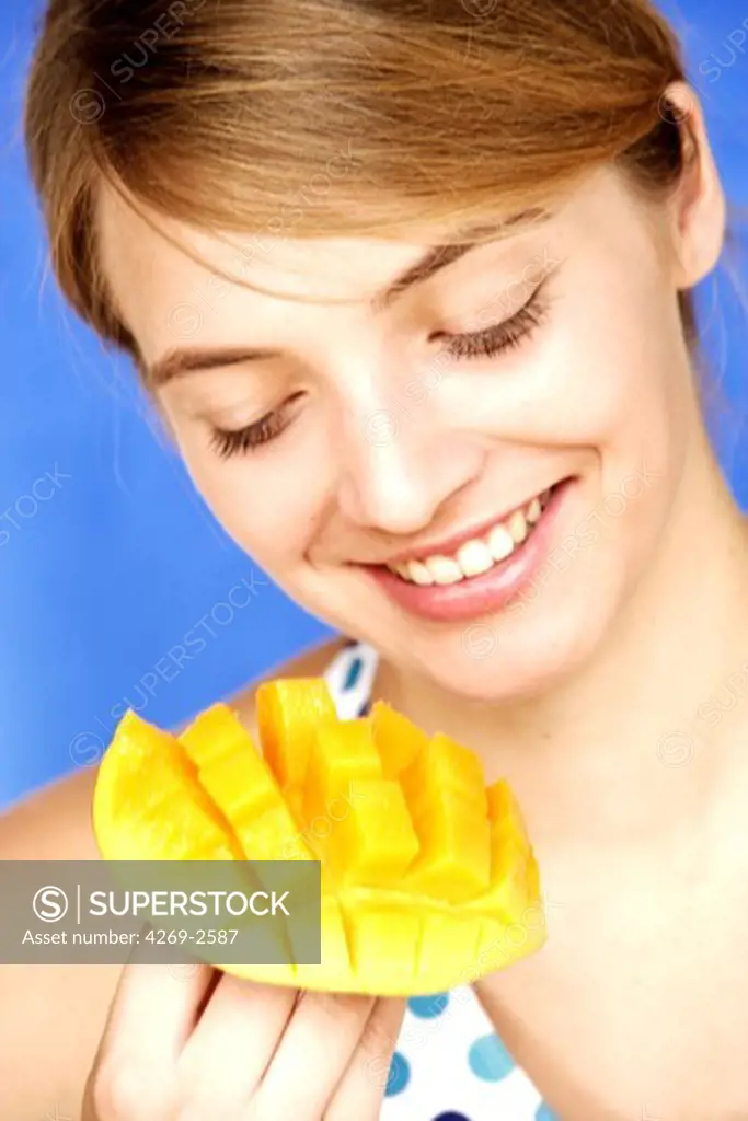 Woman eating mango.