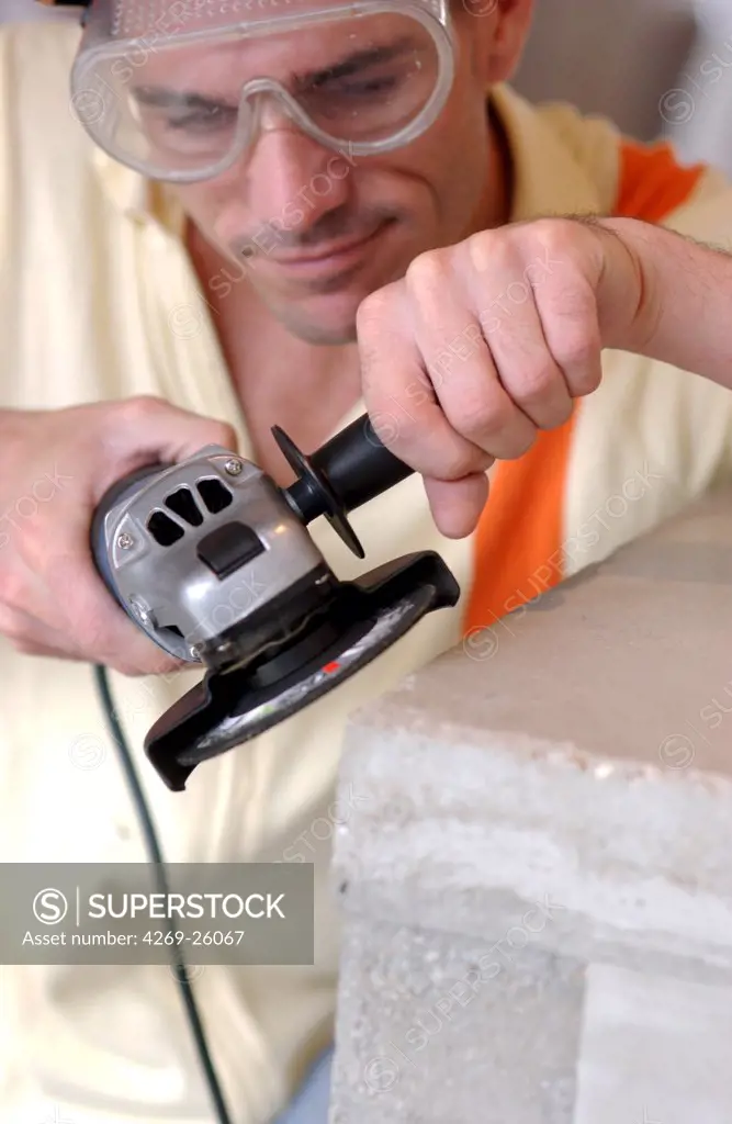 Do-it-yourself. Man using an abrazer (sander) for Do It yourself.