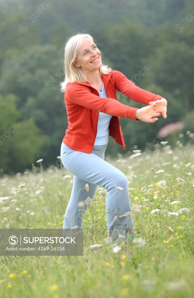 Sport. 50 years old woman stretching.