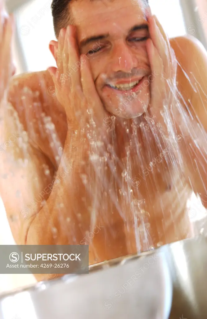 Man. Man washing his face.
