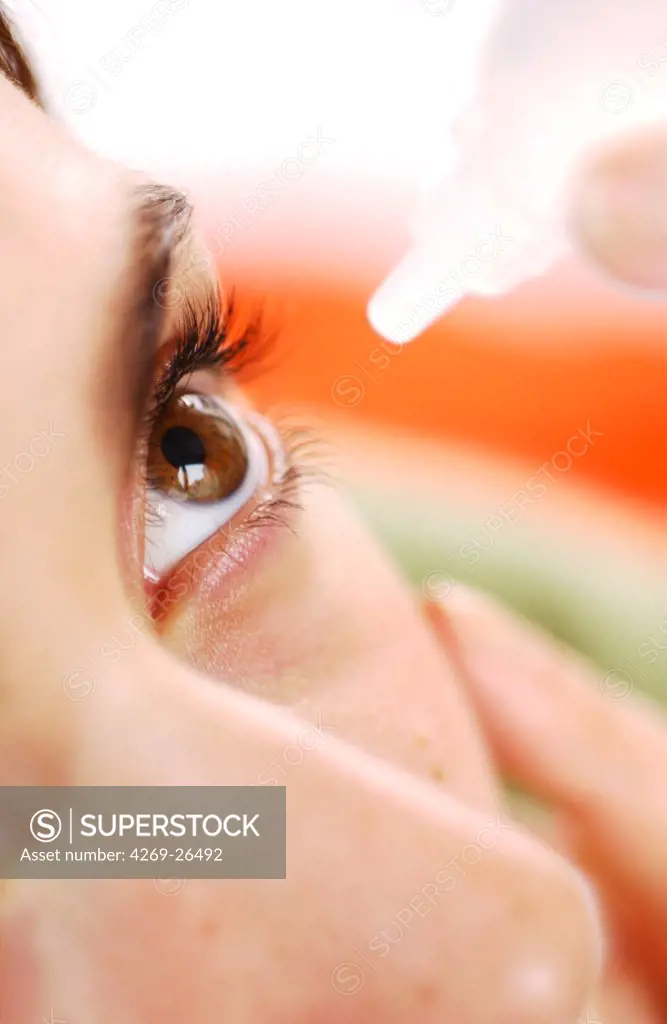 Collyrium. Woman applying eye-drops into her eye.