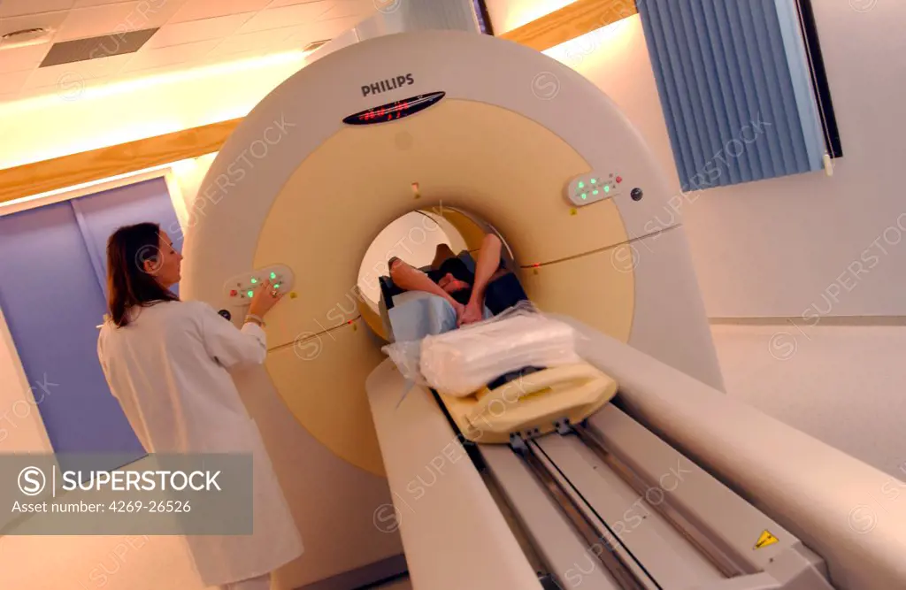 PET scan. Patient undergoing a positron emission tomography (PET) scan. A positon emission tomography exam allows the study of metabolic function of organs. It detects the presence of radioactive tracer molecules that have been injected into the patient's bloodstream and absorbed into the tissues.