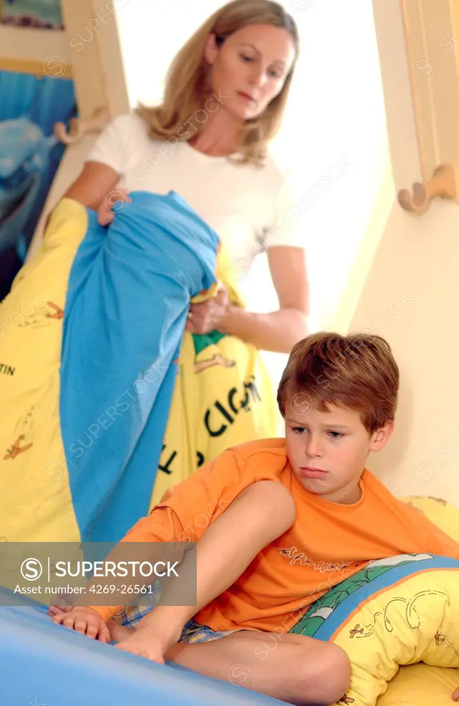 Child. 8 years old boy in his bedroom with his mother.