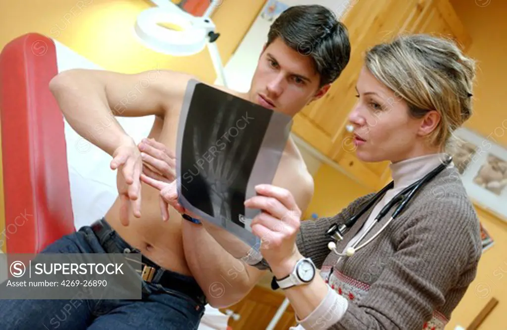 Medical consultation. a doctor examines the wrist of a patient with X-ray.