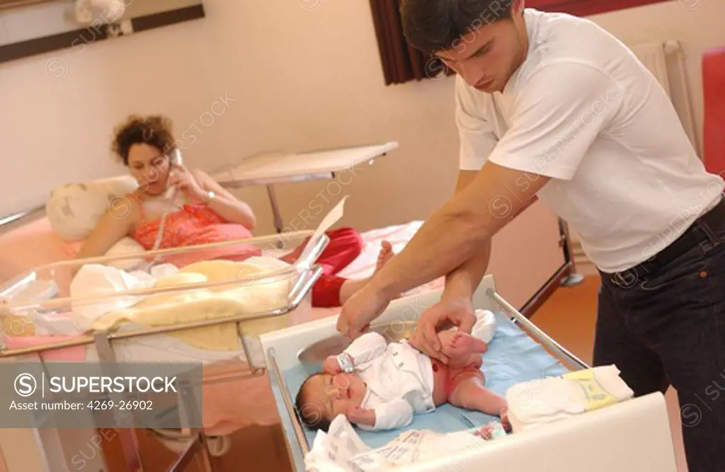 Maternity clinic. Department of obstetrics and gynecology. 4 days old newborn baby with his parents at the maternity clinic.