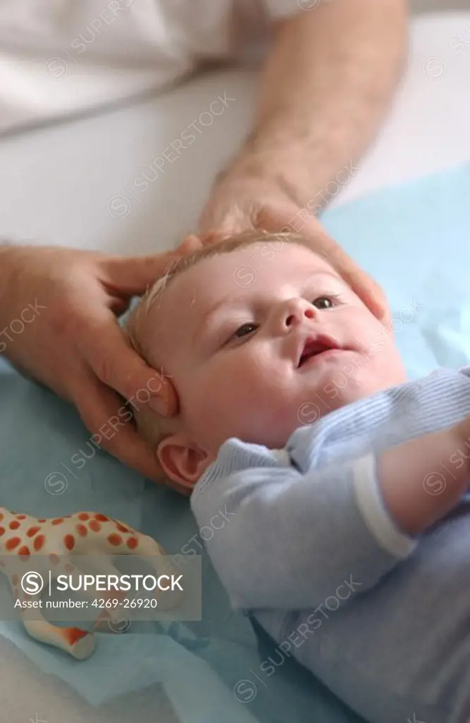 Osteopathy on a baby. Craniosacral manipulations on a 5 months old baby. Osteopathy uses massage and manipulation to treat a range of disorders, based on knowledge of the musculoskeletal system. Craniosacral techniques manipulate the bones of the skull, face and jaw.