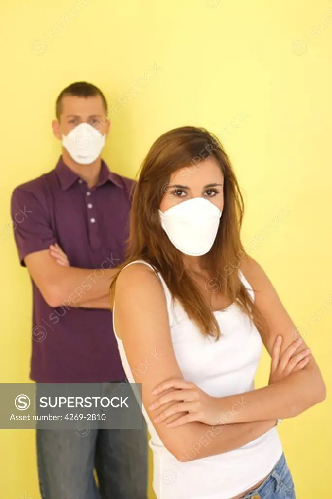 Couple wearing a protective breathing mask FFP2 (in conformity with the standard EN149:2001). It is recommended to wear this mask in case of flu pandemic.