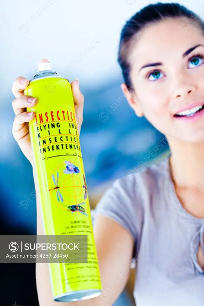 Woman using an insecticide in spray.