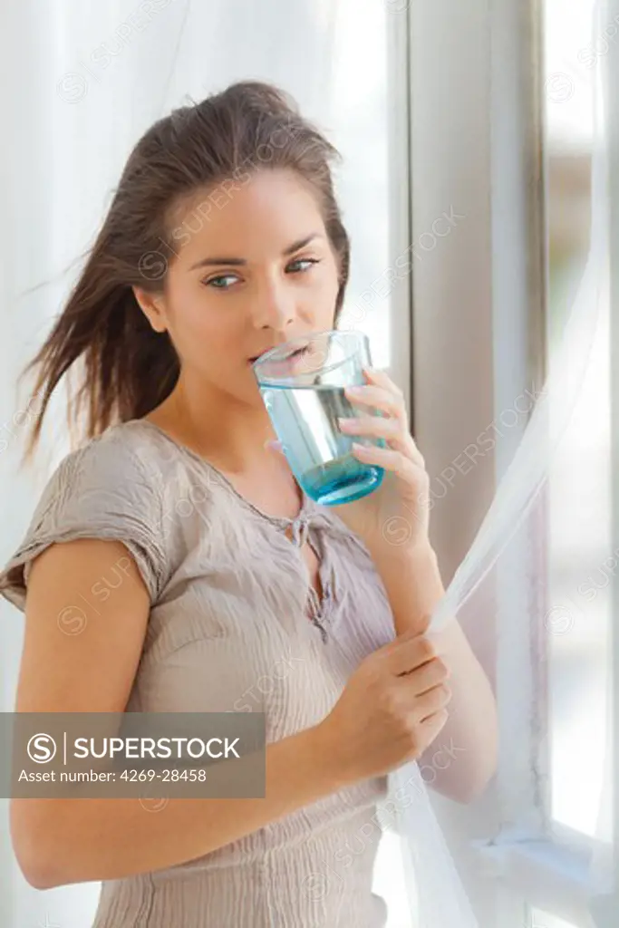 Woman drinking glass of water.