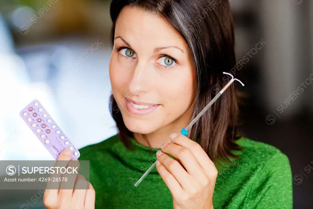 Woman holding various contraceptives.