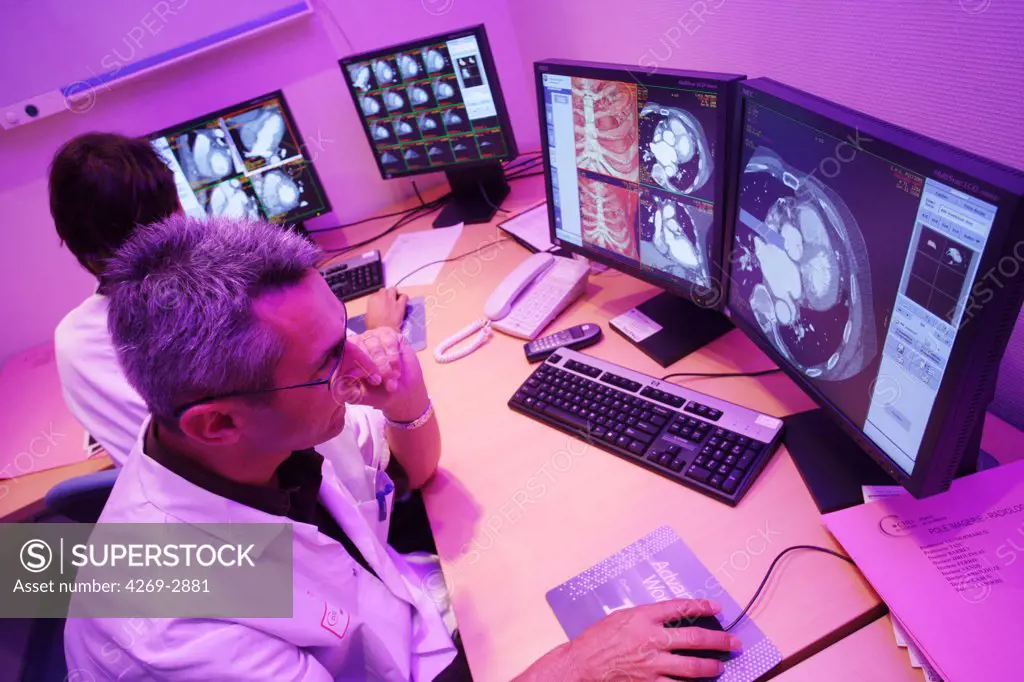 The 64-Slice CT Scanner produces 64 slices per rotation. This advanced equipment is the first in France used only for heart diagnostic. The very high definition 3D images produced in less than 10 secondes are a usefull non invasive technique to observe a mobile organs like the heart. Here, cardiologists examine imagery in the Ct scans interpretation room. Heart and Lung Center, department of Pr Allal, University Hospital of Poitiers, France.