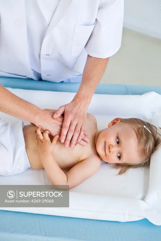 Doctor performing respiratory physiotherapy on a 17 months old infant.