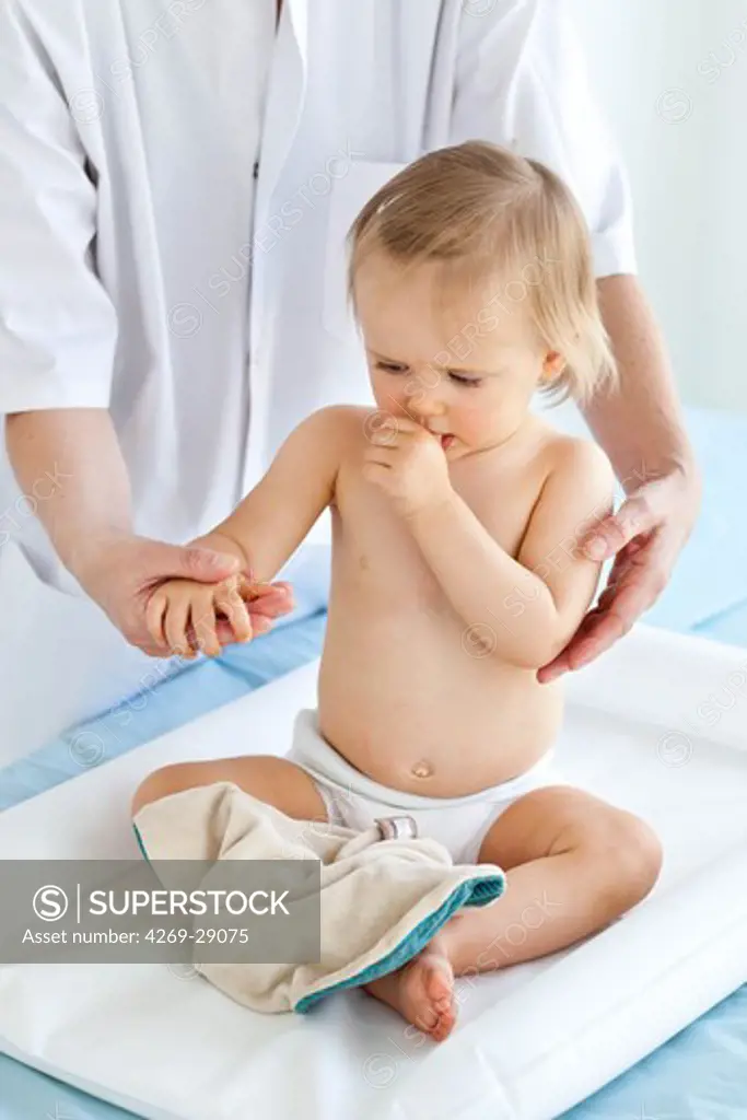 Pediatrician examining 15 months old baby.