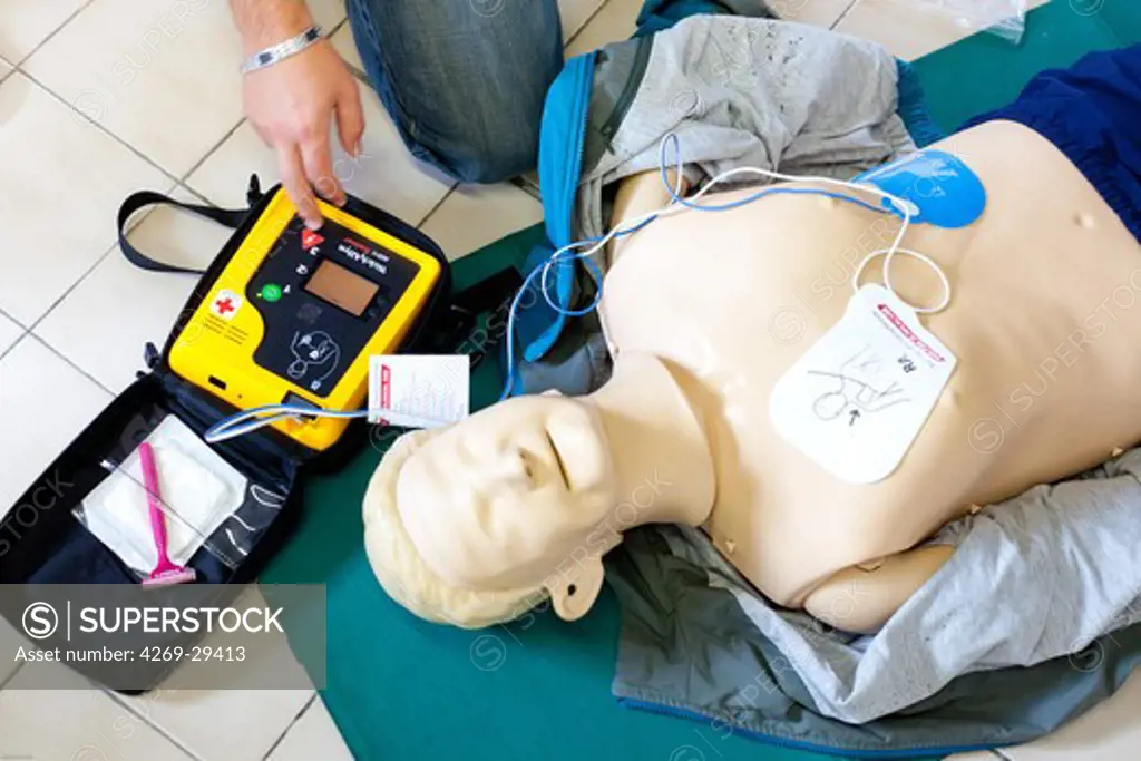 First aid training courses. Portable semi-automatic heart defibrillator used on a mannequin.