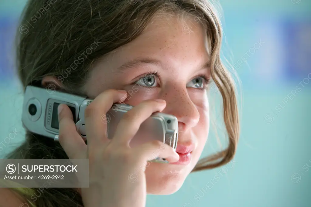12 years old girl talking on a cell phone.