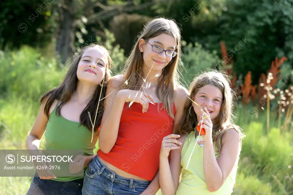 Three sisters form 11 to 14 years old outdoor.