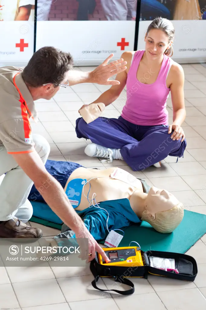 First aid training courses given by the French Red Cross. Portable semi-automatic heart defibrillator used on a mannequin.