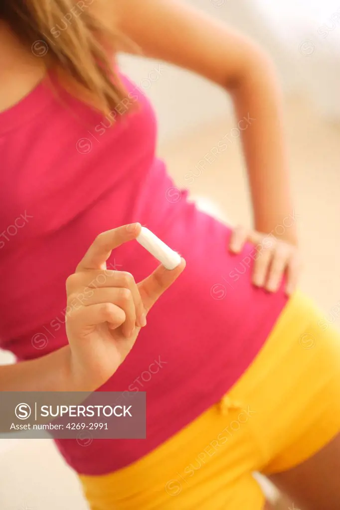 Woman holding a tampon.