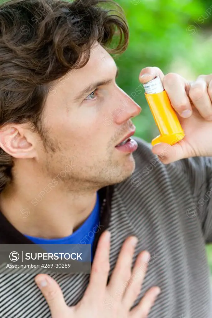 Man using an inhaler during an asthma attack.