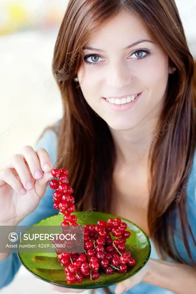 Woman. Woman eating red currants