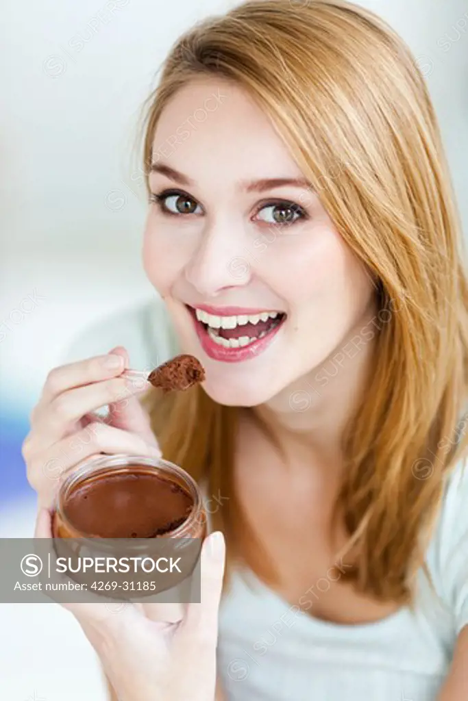 Woman eating a chocolate mousse.
