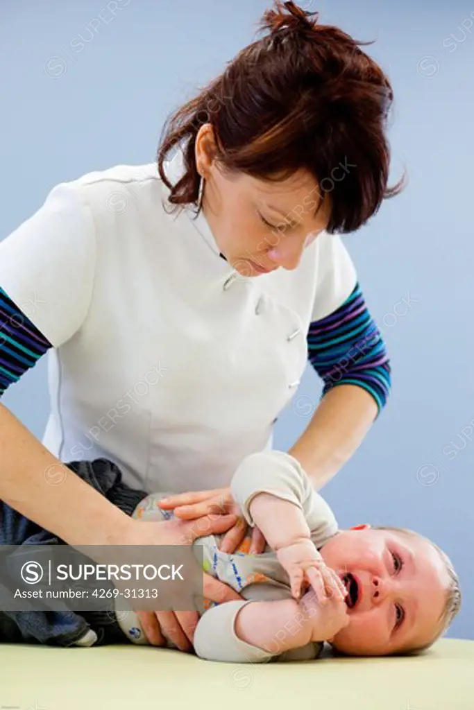 Physical Therapist performing respiratory physiotherapy on baby.
