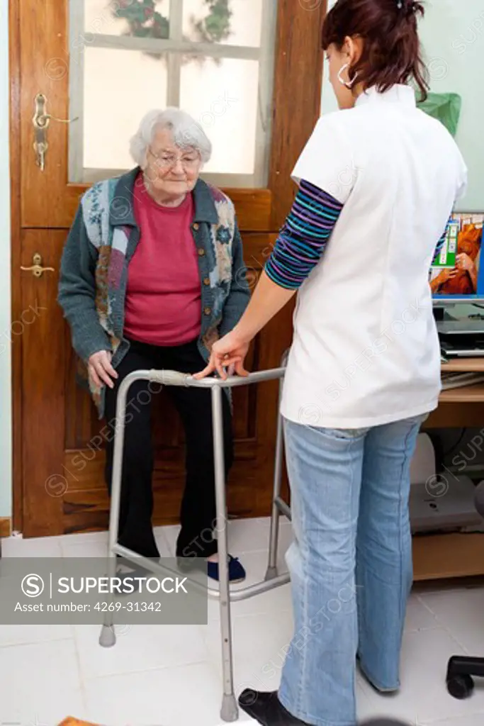Physiotherapy session at the home of an elderly woman following fracture.
