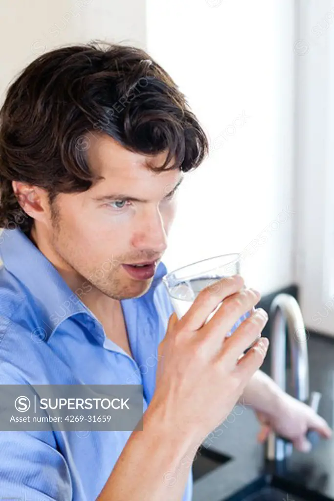 Man drinking glass of water.
