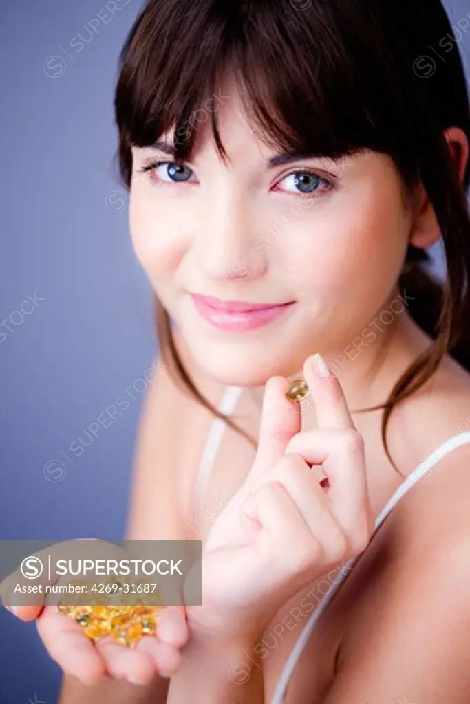woman taking food supplement capsules.