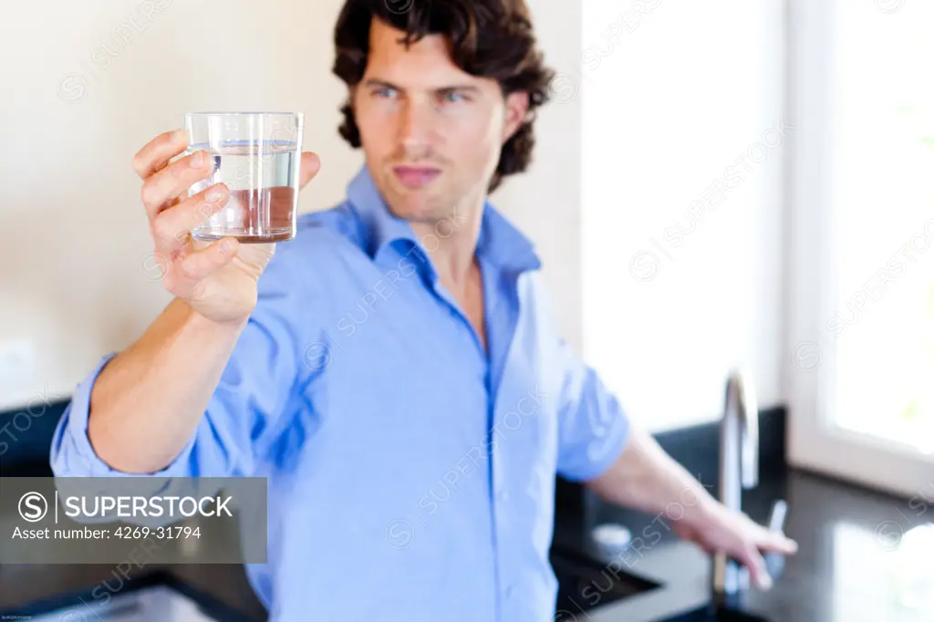 Man drinking glass of water.