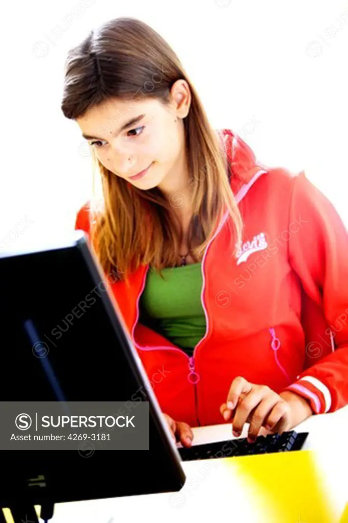 Teenage girl using computer.