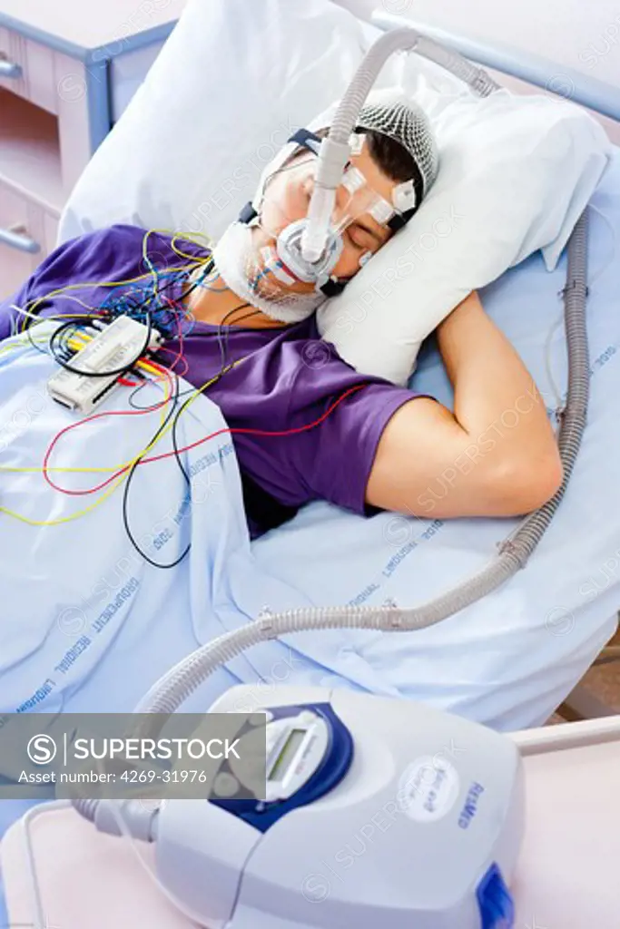 Patient suffering from Obstructive Sleep Apnea Syndrome (OSAS) connected to a continuous positive airway pressure device (CPAP). Limoges hospital, France.