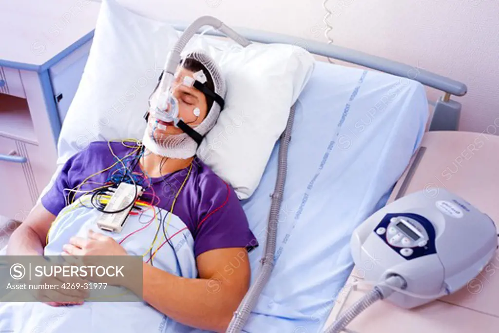 Patient suffering from Obstructive Sleep Apnea Syndrome (OSAS) connected to a continuous positive airway pressure device (CPAP). Limoges hospital, France.