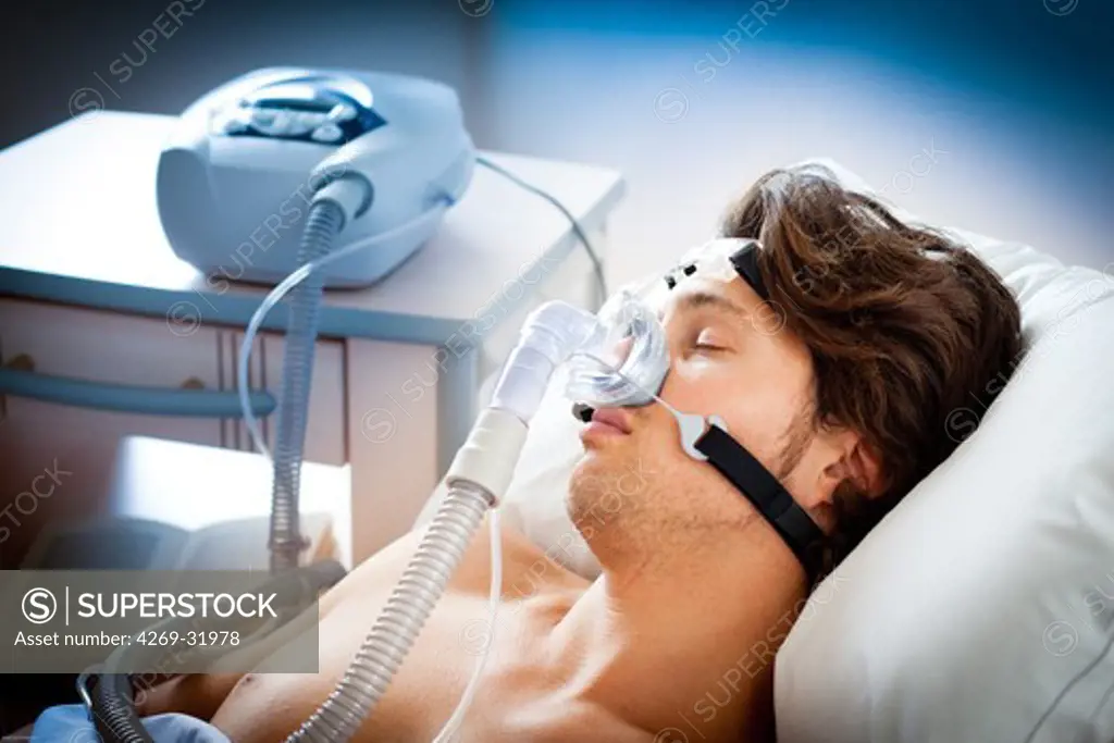 Treatment of sleep apnea and snoring : patient suffering from Obstructive Sleep Apnea Syndrome (OSAS) connected to a continuous positive airway pressure device (CPAP).
