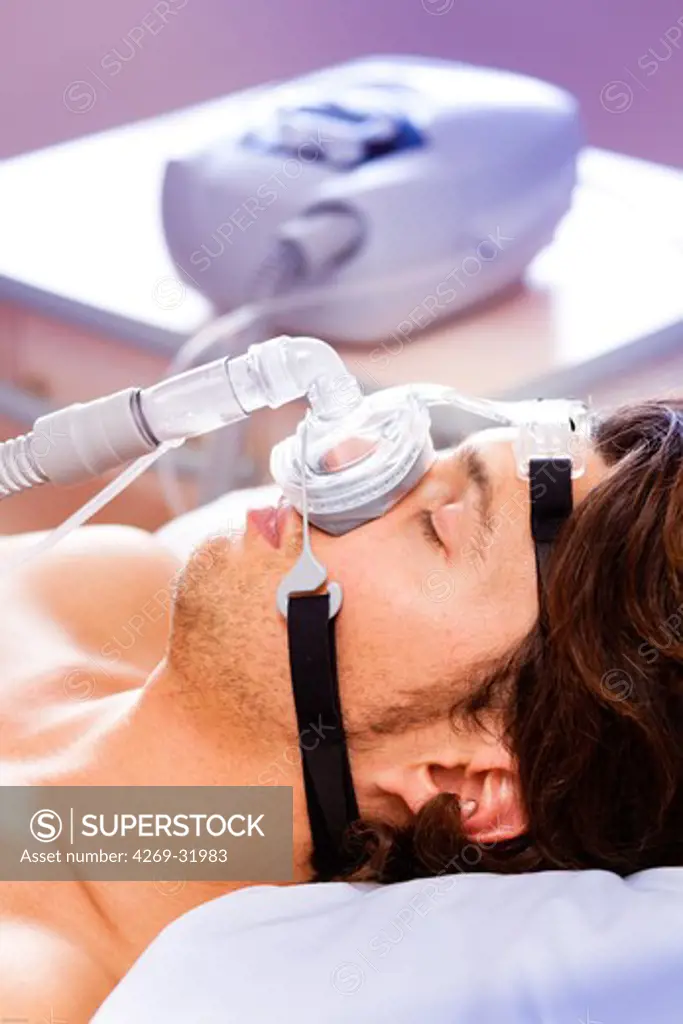 Treatment of sleep apnea and snoring : patient suffering from Obstructive Sleep Apnea Syndrome (OSAS) connected to a continuous positive airway pressure device (CPAP).