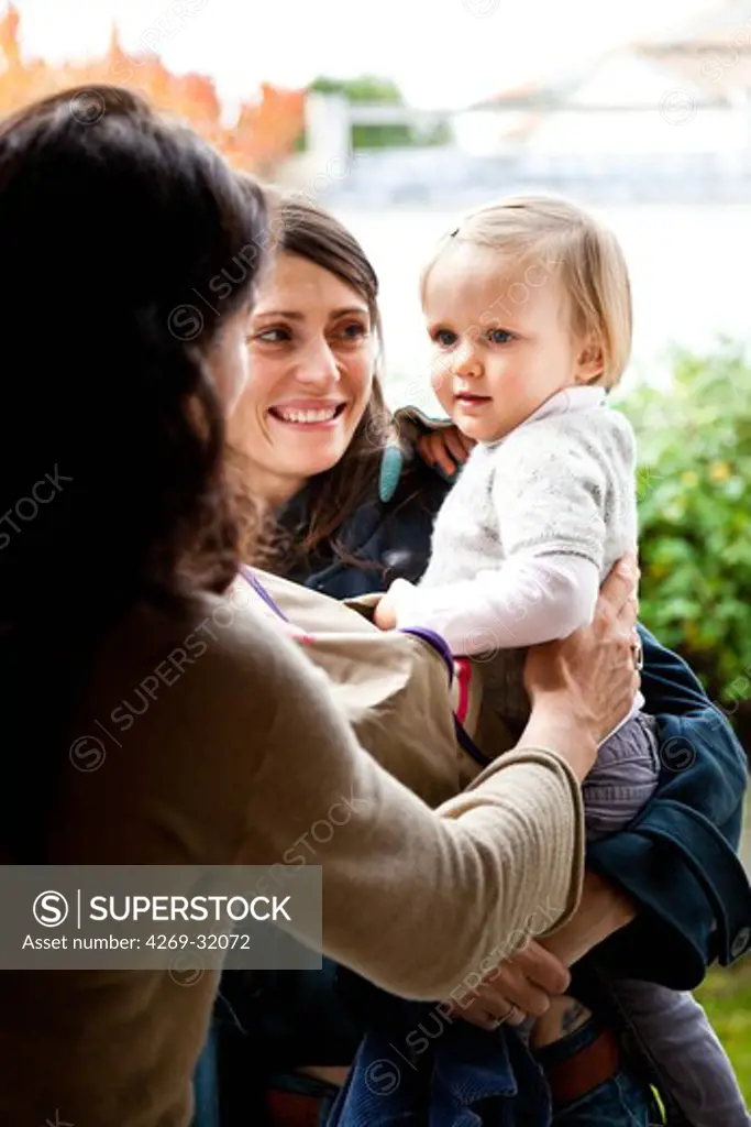 A mother takes her 18 month old baby girl to a baby caregiver.