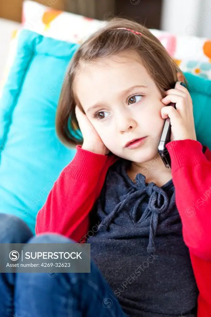 4 year old girl using a cell phone.