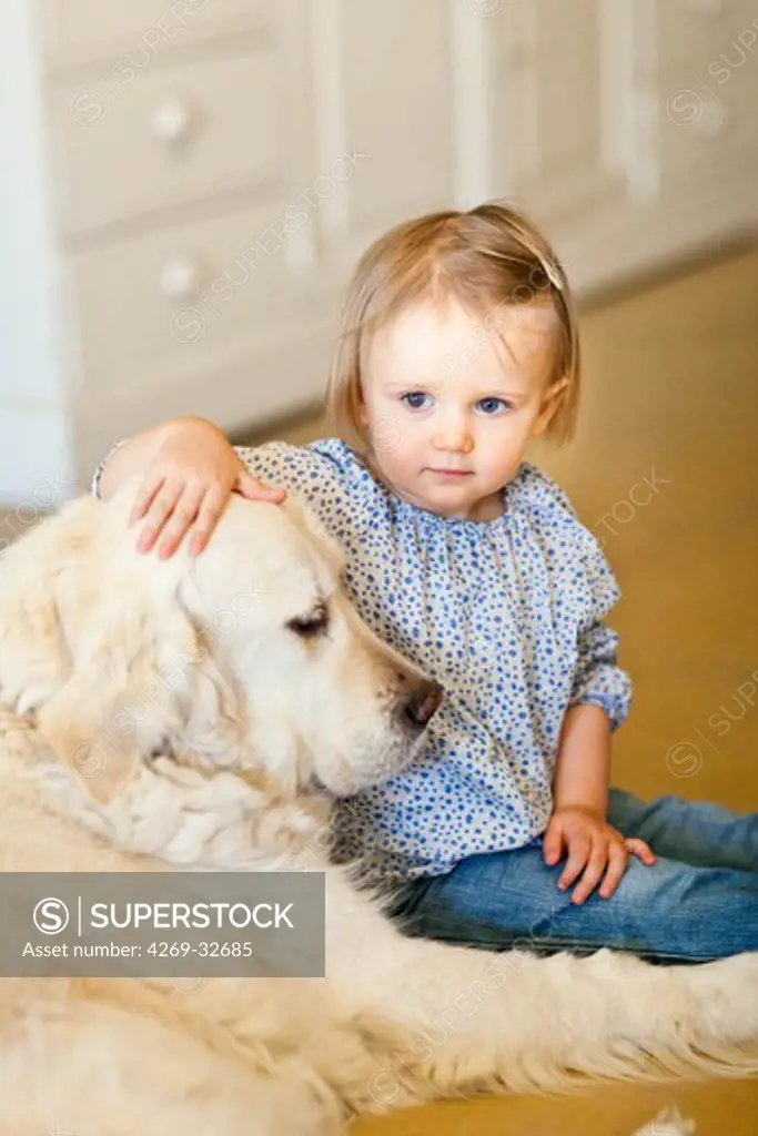 24 month old baby girl with a dog.
