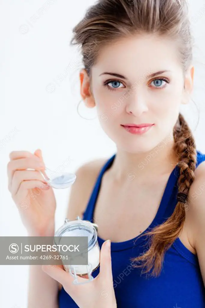 woman taking powder of sodium bicarbonate or baking soda.
