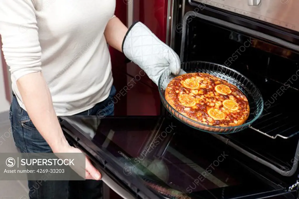 woman using oven.