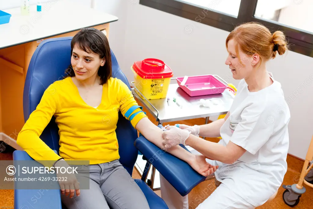 Young woman having a blood sample.