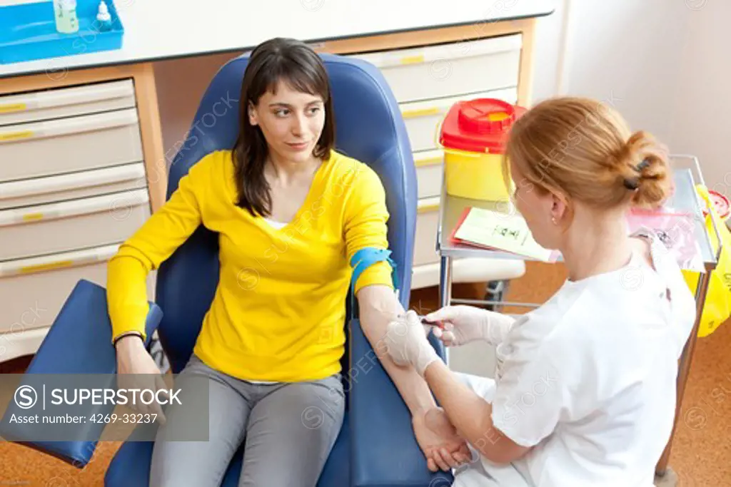 Young woman having a blood sample.