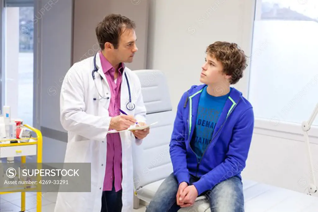 Doctor talking with teenage patient.