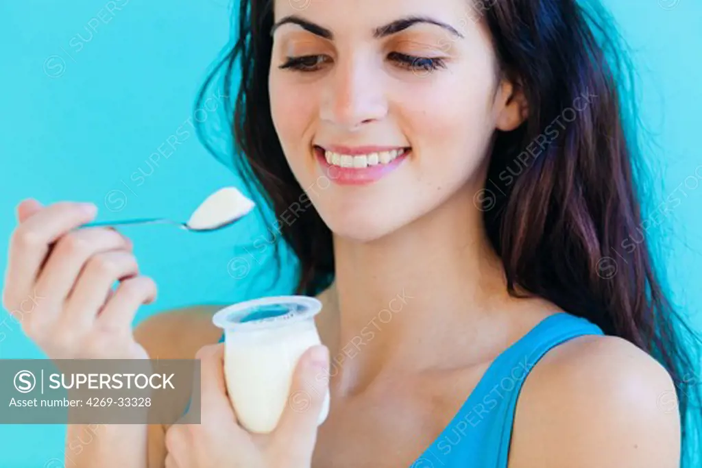 woman eating a yogurt.