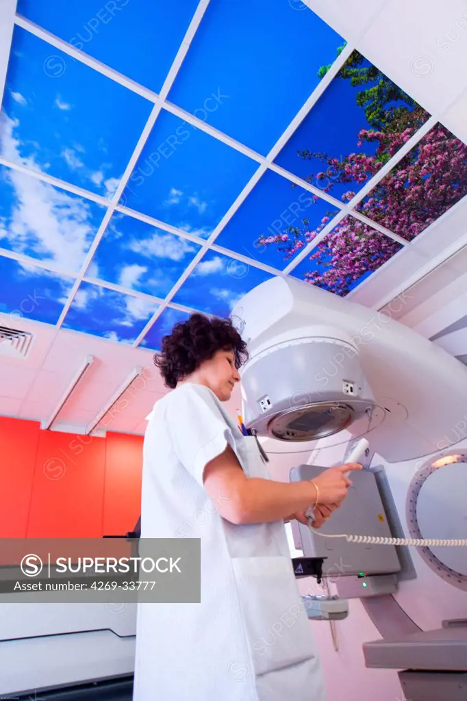 Radiotherapy radiographer adjusting a luminous ceiling latest generation particle accelerator. Radiotherapy center pole of Oncology Hospital of Bordeaux. Hospital Haut-Leveque.