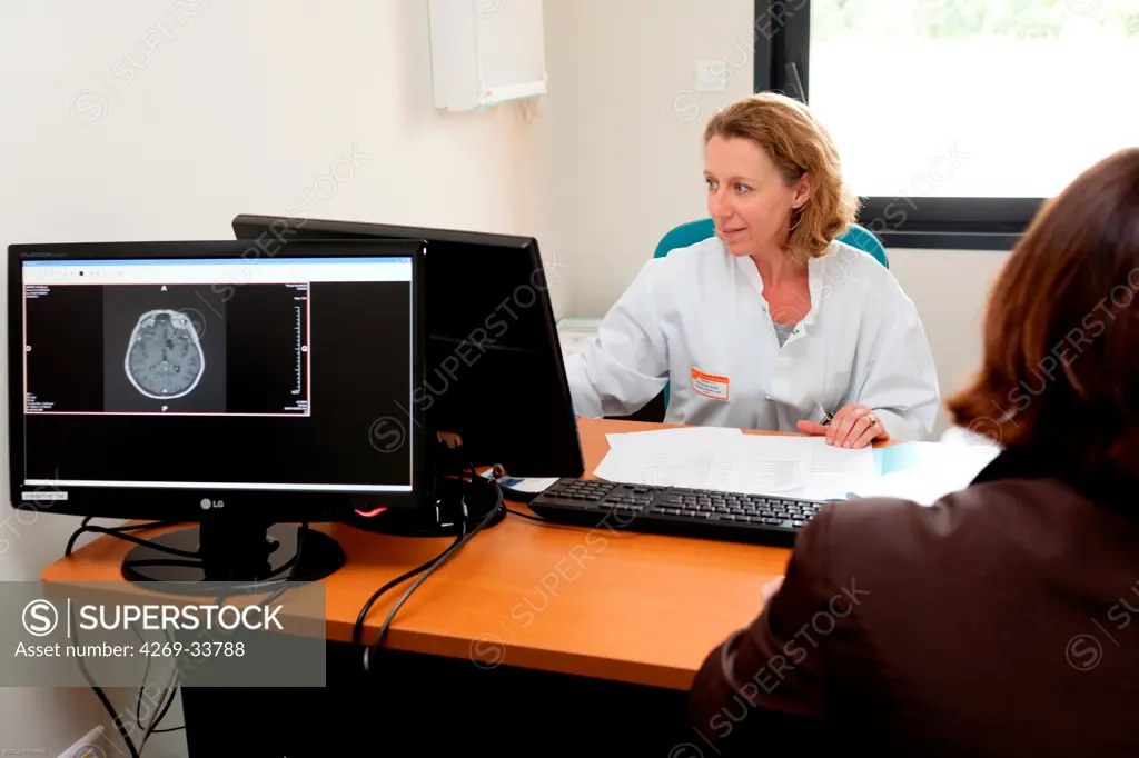 Cancer radiotherapist with a female patient suffering from brain cancer in consultation for medical follow after radiotherapy treatment. Radiotherapy center, pole of Oncology, Hospital of Bordeaux. Hospital Haut-Leveque.