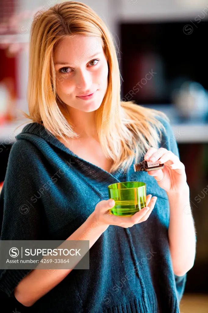 Woman using essential oil.